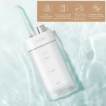 Portable water flosser on light blue surface
