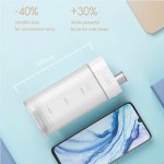 Compact portable water flosser beside smartphone