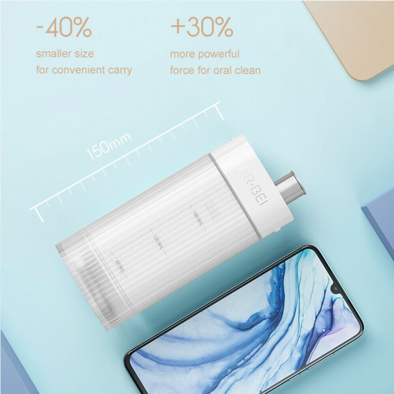 Compact portable water flosser beside smartphone