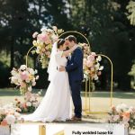 arch backdrop stand, set of 3, 1.8/1.5/1.2 m, stable structure, easy assembly, gold metal arch backdrop stand for wedding, birthday party, graduation, celebration, and ceremony decoration Bride and groom under floral wedding arch outdoors