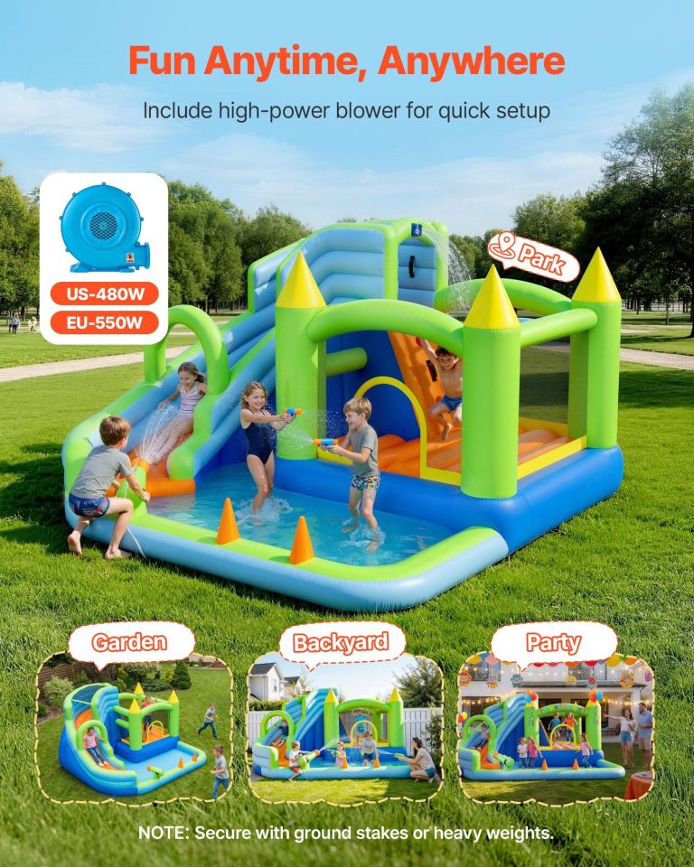 Kids playing on inflatable water slide in park