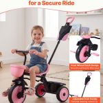 Girl riding pink tricycle with parent handle