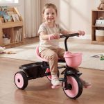 Smiling child riding pink tricycle indoors