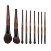 Set of wooden-handled makeup brushes on white background