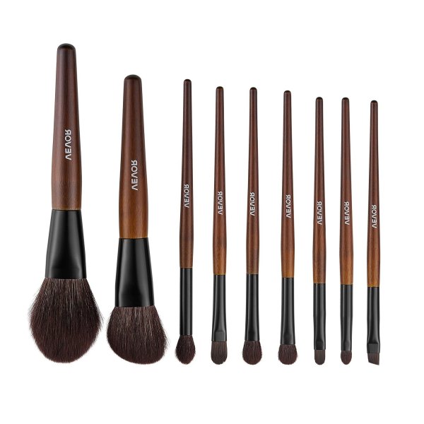 Set of wooden-handled makeup brushes on white background