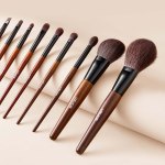 9 piece makeup brush set for foundation blending eyeshadow, professional makeup brush kit with soft natural wool & vegan synthetic bristles, ergonomic wood handle, travel friendly storage bag Set of wooden-handled makeup brushes on beige background
