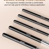 Glossy black wooden makeup brush handles close-up