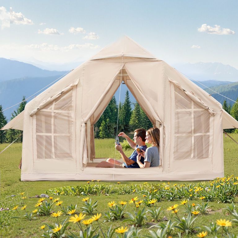 Couple relaxing in canvas tent with mountain view