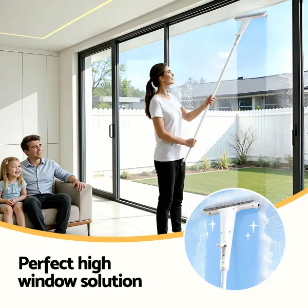 Woman cleaning high window with long-handled squeegee