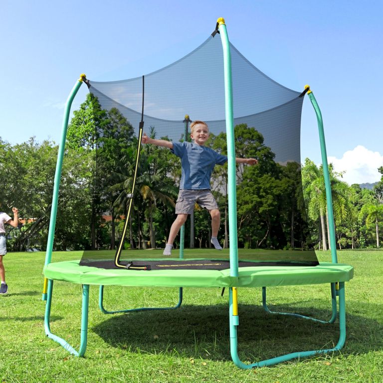 Boy jumping on trampoline in sunny park