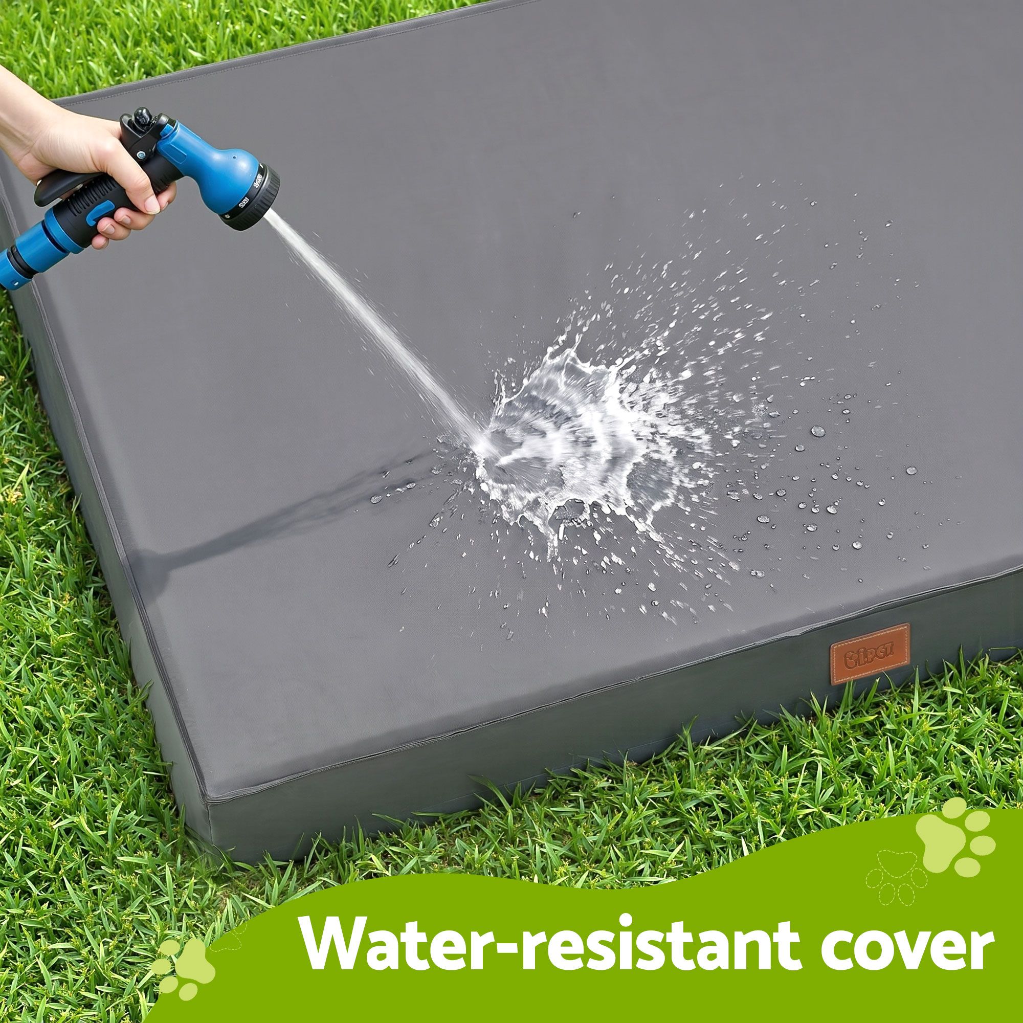 Hose spraying water on grey outdoor cushion