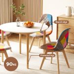 Round white dining table with patchwork chairs