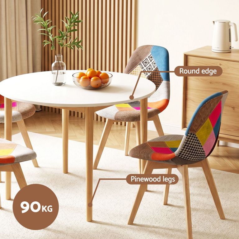 Round white dining table with patchwork chairs