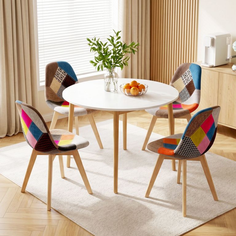 Round dining table with colourful patchwork chairs