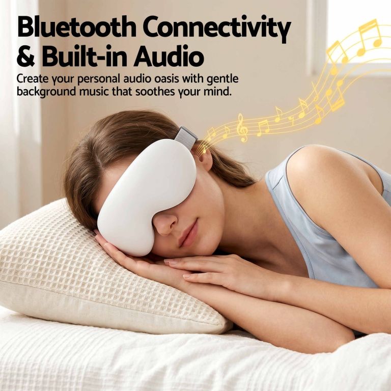 livemor eye massager with cooling & heating | dual hot cold compress goggles with 12 vibrating nodes for migraine relief | wireless bluetooth eye mask with 10min timer & 2400mah battery, white Woman wearing Bluetooth eye massager with built-in audio