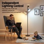 Man working beside adjustable floor lamp at home