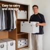 Man holding portable storage box in wardrobe