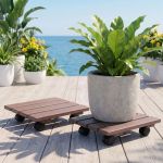 Potted plants on wheeled stands by ocean deck