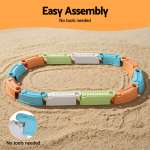 Colourful interlocking toy track pieces on sand