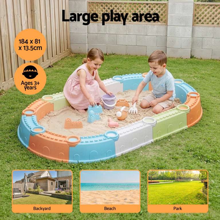 Children playing in large outdoor sandbox
