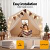 Child reading in festive indoor play tent