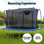 Child jumping on rectangular backyard trampoline with net
