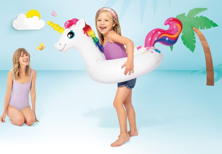 intex big animal rings 58221 Girl wearing unicorn pool float beside smiling woman