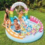 Family playing in inflatable backyard splash pool