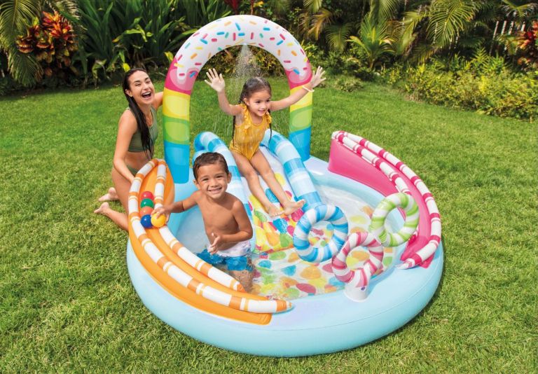 Family playing in inflatable backyard splash pool