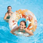 Mother and daughter playing with pool float