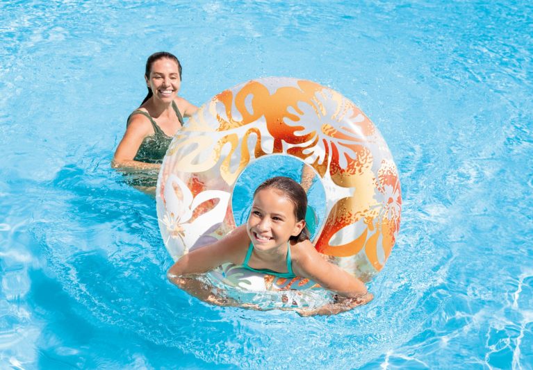 Mother and daughter playing with pool float