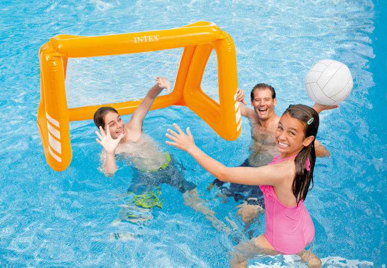 Family playing pool volleyball with inflatable goal