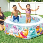 Family splashing in backyard inflatable pool