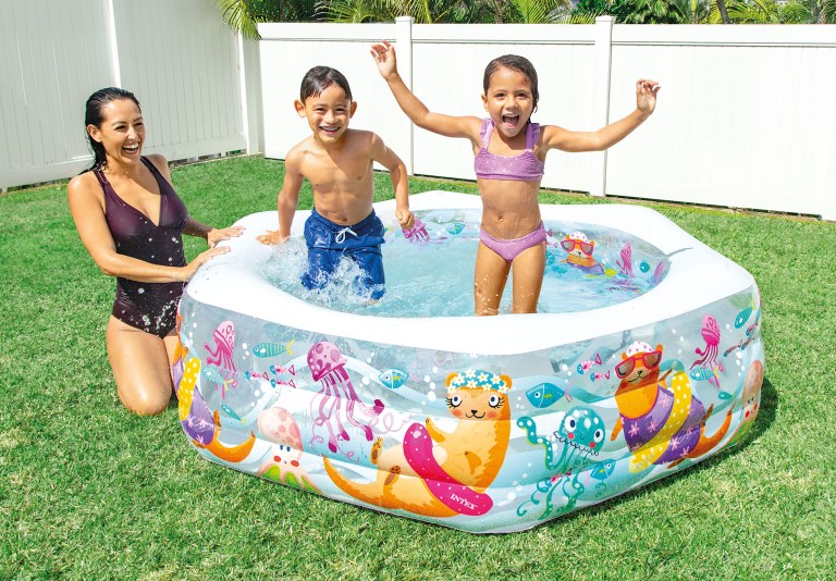Family splashing in backyard inflatable pool