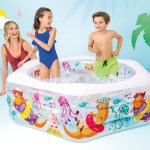 Children splashing in colourful inflatable backyard pool