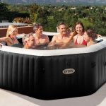 Six adults relaxing in outdoor inflatable spa