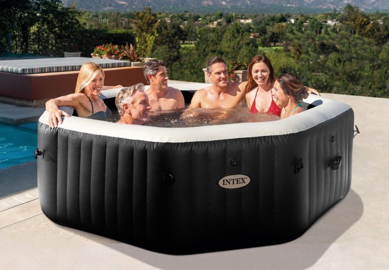 Six adults relaxing in outdoor inflatable spa