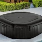 Black inflatable outdoor spa with fitted cover
