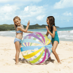 Two girls playing with colourful beach ball