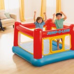intex jump o lene inflatable bouncer play house 48260 Two children jumping in indoor inflatable castle
