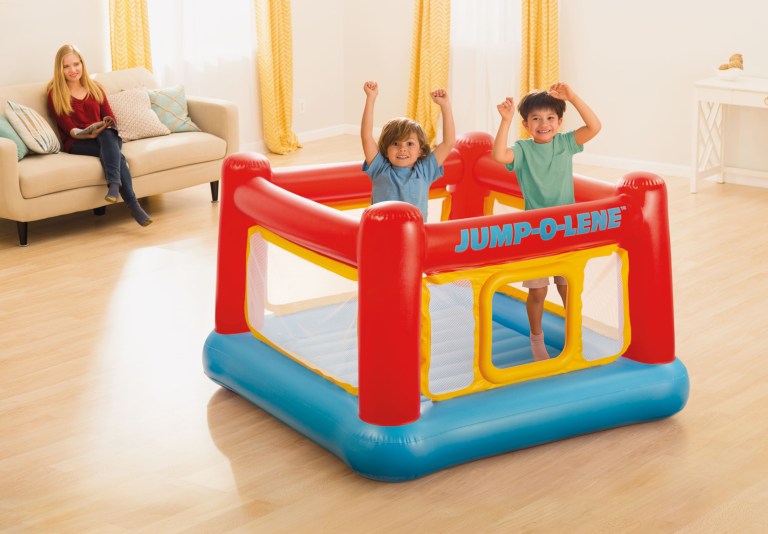 intex jump o lene inflatable bouncer play house 48260 Two children jumping in indoor inflatable castle