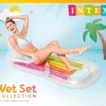 Woman lounging on rainbow inflatable pool float