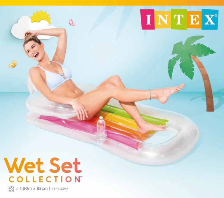 Woman lounging on rainbow inflatable pool float
