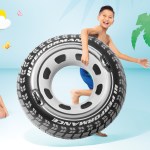 intex monster truck tube 56268 Boy holding tyre-shaped pool float beside smiling woman