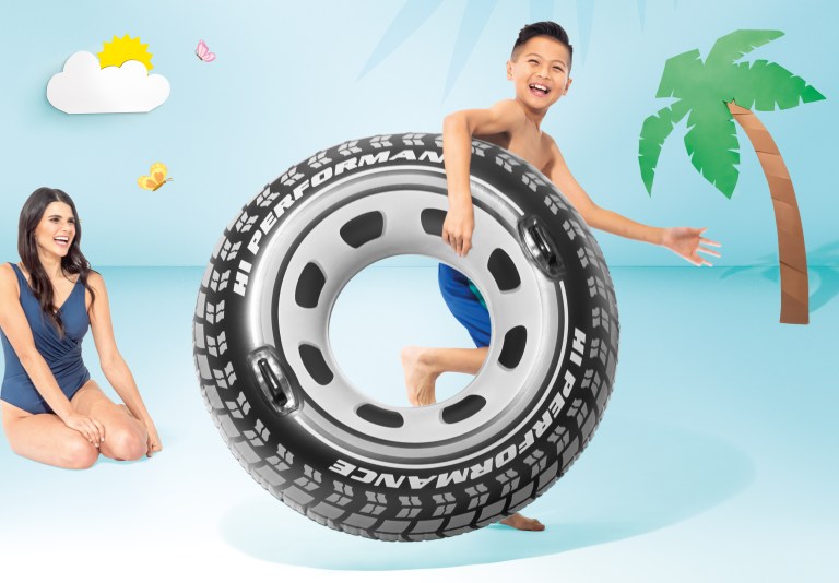 intex monster truck tube 56268 Boy holding tyre-shaped pool float beside smiling woman