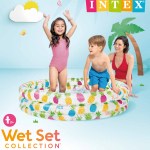 Children playing in pineapple inflatable paddling pool