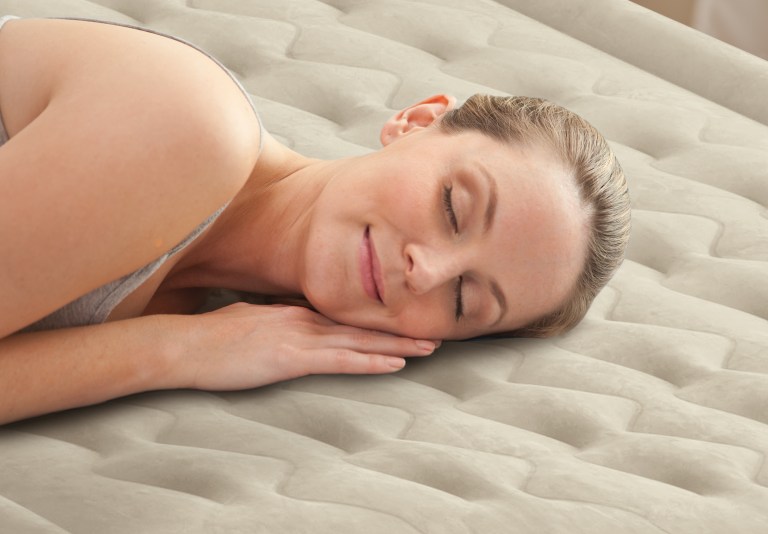 Woman sleeping peacefully on a mattress