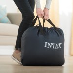Person lifting navy INTEX carry bag indoors