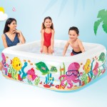 Children playing in colourful inflatable backyard pool