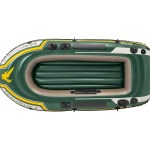 Green inflatable dinghy on white background